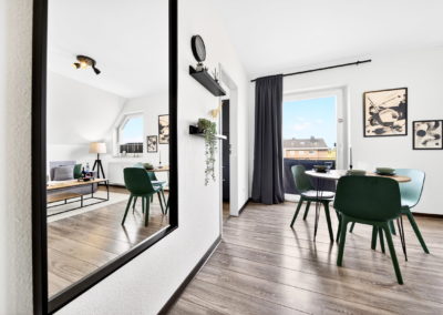 Essbereich mit grünen Stühlen in einem möblierten Apartment in Kaarst